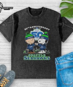Alt Text: Original Snoopy and Charlie Brown Peanuts Seattle Seahawks 50th Anniversary 1976-2025 washed t-shirt design.