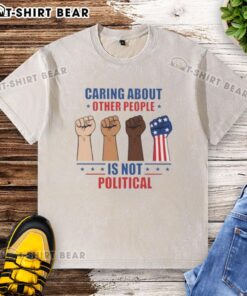 Premium 'Caring About Other People Is Not Political' Fists Washed T-Shirt, featuring a bold graphic design on a soft fabric.