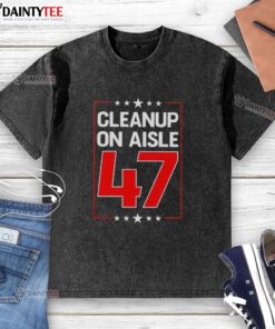 Premium Clean Up On Aisle 47 washed t-shirt displayed on a wooden surface, showcasing its soft fabric and vibrant design.