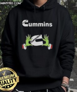 Premium Grinch hands holding a Cummins Christmas hoodie, perfect for festive holiday style and diesel enthusiasts.