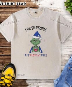 Alt Text: Premium Grinch I Hate People But I Love My Buffalo Bills Merry Christmas washed t-shirt in festive holiday colors.