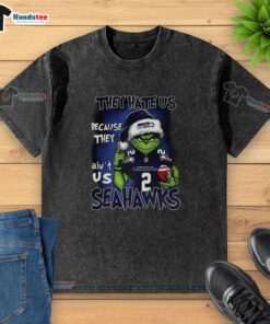 Premium Grinch Santa Hat T-shirt featuring Seattle Seahawks NFL design - 'They Hate Us Because They Ain't Us' Christmas theme.