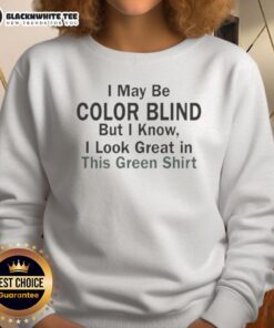 Alt Text: Man wearing a green sweatshirt with the phrase 'I May Be Color Blind But I Know I Look Green' in a casual setting.