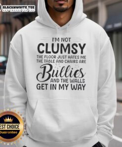 Premium hoodie featuring 'I'm Not Clumsy, The Floor Hates Me' design, perfect for casual wear and humor lovers.