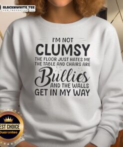 Alt Text: Premium I'm Not Clumsy, The Floor Hates Me sweatshirt, featuring a humorous design with table and chairs graphics.