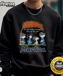 Alt Text: Premium Miami Marlins X Peanuts Snoopy and Friends sweatshirt featuring autumn design, perfect for the holiday season.