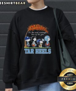 Alt Text: Premium North Carolina Tar Heels X Peanuts Snoopy sweatshirt featuring autumn design, perfect for cozy fall days.