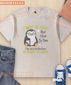 Premium penguin washed t-shirt featuring 'I may be old but I got to see the world before it went to shit' design.