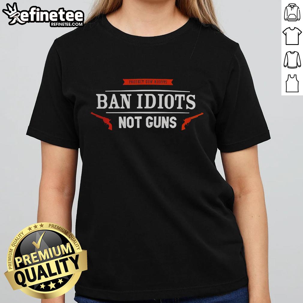 premium-protect-gun-rights-ban-idiots-not-guns-ladies-tee Premium Protect Gun Rights 'Ban Idiots Not Guns' Ladies Tee featuring bold text design on a stylish women's shirt.