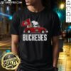 Alt Text: Premium Snoopy and Woodstock driving a car wearing Ohio State Buckeyes flag t-shirt, perfect for fans.