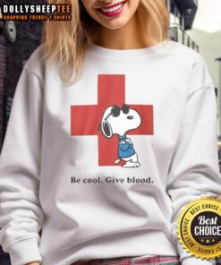 Premium Snoopy Be Cool Give Blood Sweatshirt featuring a playful Snoopy graphic, perfect for casual wear and dog lovers.