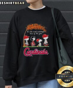Premium St. Louis Cardinals sweatshirt featuring Snoopy and friends, perfect for autumn and the holiday season.