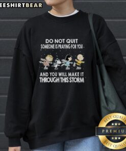 Alt Text: Cozy Premium Peanuts sweatshirt with motivational quote Do Not Quit, Someone Is Praying For You. Perfect for staying warm.