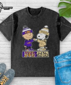 Pretty Charlie Brown fist bumping Snoopy in LSU Tigers x New Orleans Saints washed t-shirt, showcasing Louisiana city spirit.