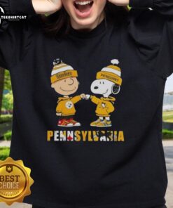 Pretty Charlie Brown fist bump with Snoopy in Pittsburgh Steelers & Penguins sweatshirt, perfect for Pennsylvania city sports fans.