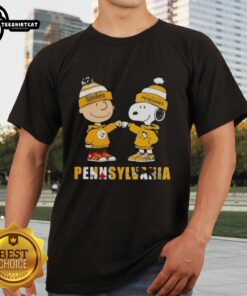 Pretty Charlie Brown fist bump with Snoopy on a Pittsburgh Steelers X Penguins T-shirt, perfect for sports fans.