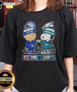 Pretty Charlie Brown fist bump with Snoopy in Philadelphia skyline, featuring 76ers and Eagles, ladies tee design.