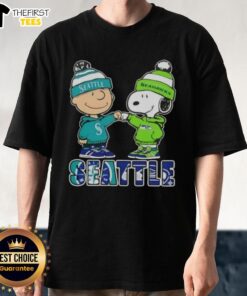 Alt Text: Pretty Charlie Brown fist bump with Snoopy on Seattle sports T-shirt featuring Mariners and Seahawks logos.
