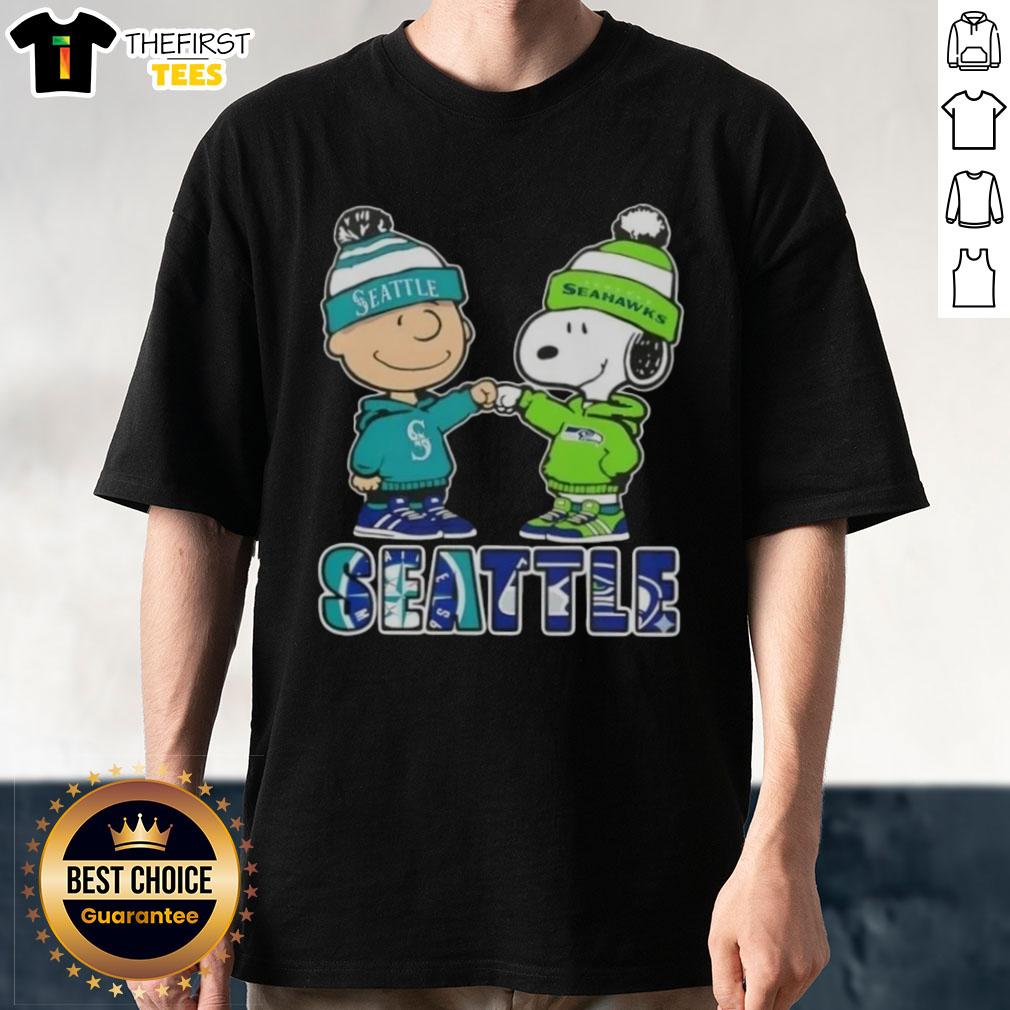 pretty-charlie-brown-fist-bump-snoopy-seattle-city-sports-mariners-x-seahawks-t-shirt Alt Text: Pretty Charlie Brown fist bump with Snoopy on Seattle sports T-shirt featuring Mariners and Seahawks logos.
