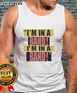 Hayley Williams wearing 'I'm In A Band' tank top, showcasing her signature style and vibrant personality in a lively setting.