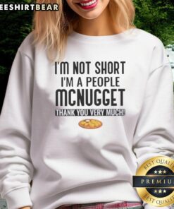 Cozy sweatshirt featuring 'Pretty I'm Not Short I'm A People McNugget Thank You Very Much' in playful typography.