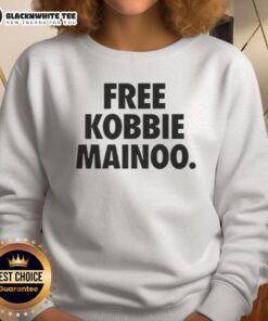 Brother of Man United's Kobbie Mainoo wearing a stylish Free Kobbie Mainoo sweatshirt, showcasing team spirit.