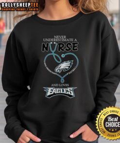 Alt Text: Pretty sweatshirt saying 'Never underestimate a nurse who loves football' with Philadelphia Eagles theme.