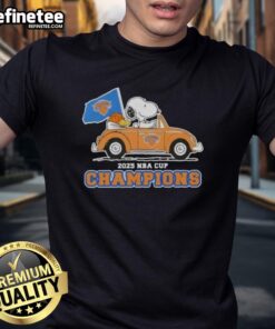 Alt Text: Pretty Peanuts Snoopy driving a car on a New York Knicks T-shirt celebrating the 2025 NBA Cup Champions.