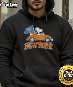 Snoopy driving a car in a New York Knicks basketball hoodie featuring pretty peanuts design.