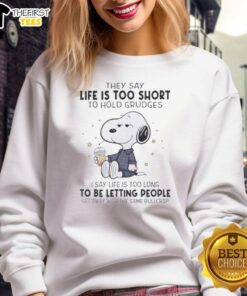 Pretty Peanuts sweatshirt with a quote: 'Life is too short to hold grudges, too long to let people sweat.' Stylish and cozy.