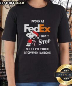 Alt Text: Pretty Snoopy Christmas tee for ladies with 'I work at FedEx, I don't stop when I'm tired' slogan.