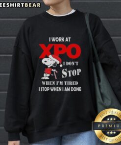 Pretty Snoopy Christmas sweatshirt with 'I work at XPO, I don't stop when I'm tired, I stop when I'm done' slogan.