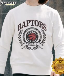 Alt Text: Retro sweatshirt featuring the Toronto Raptors NBA logo framed by a laurel wreath, perfect for basketball fans.