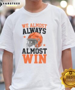 Funny football fan t-shirt featuring 'Pretty We Almost Always Almost Win' slogan, perfect for game day enthusiasm.