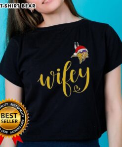 Alt Text: Pretty Wifey Minnesota Vikings Santa hat tee for ladies, perfect for a Merry Christmas celebration.