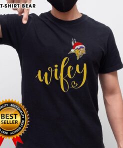 Pretty Wifey Minnesota Vikings Santa Hat Merry Christmas T-Shirt featuring festive graphics and team colors for holiday cheer.