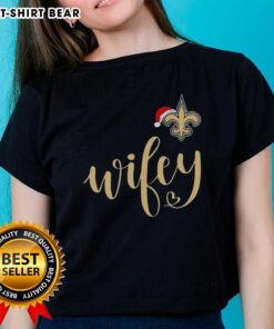 Pretty Wifey New Orleans Saints Santa Hat Merry Christmas Ladies Tee featuring festive design and team spirit.