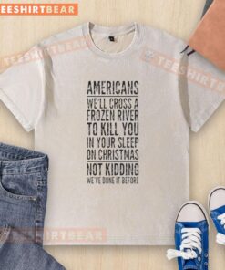 Top Americans cross a frozen river wearing a 'Kill You in Your Sleep' Christmas T-shirt, blending humor and holiday spirit.