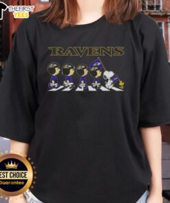 Alt Text: Top Baltimore Ravens X Peanuts Snoopy and Friends Abbey Road ladies tee featuring iconic characters and team colors.