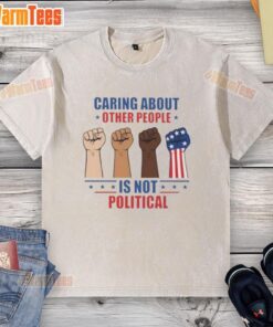 Alt Text: Top caring about other people is not political fists washed t-shirt featuring a bold, empowering design.
