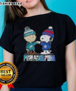 Top Charlie Brown and Snoopy Philadelphia City Sports Eagles X 76ers ladies tee featuring iconic characters and team logos.