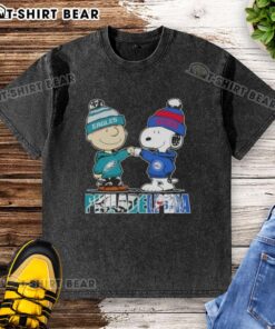 Top Charlie Brown and Snoopy Philadelphia City Sports Eagles X 76ers washed t-shirt displayed on a wooden background.