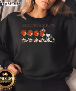 Alt Text: Cincinnati Bengals X Peanuts Snoopy and Friends Abbey Road sweatshirt featuring Snoopy and friends in Bengals colors.