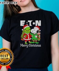 Alt Text: Ladies' tee featuring Eaton Corporation X Grinch and Snoopy designs for a merry Christmas celebration.