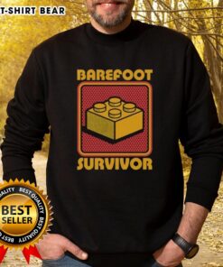 Top Foot Brick Survivor sweatshirt featuring a playful 'Barefoot Lego Survivor' design for Lego enthusiasts and fans.