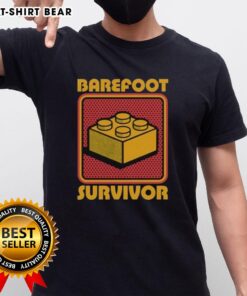 Top Foot Brick Survivor T-Shirt featuring a playful design for barefoot Lego enthusiasts and fans of fun apparel.