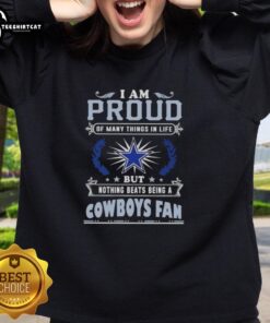 Cozy sweatshirt with 'I Am Proud Of Many Things, But Nothing Beats Being A Dallas Cowboys Fan' slogan displayed prominently.