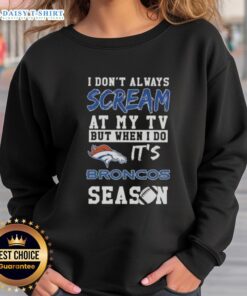 Alt Text: Cozy Denver Broncos season sweatshirt with humorous text, perfect for fans who passionately cheer at the TV.
