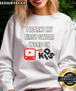 Child wearing 'I Learnt My First Swear Word On Kids YouTube' sweatshirt, showcasing playful and humorous kids' fashion.