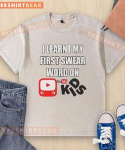 Child wearing a washed t-shirt with 'I Learnt My First Swear Word on Kids YouTube' graphic, showcasing playful humor.